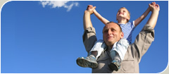 Happy grandfather with his grandson on his shoulders